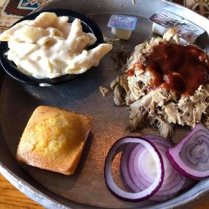 a platter of pulled pork bbq mac and cheese and cornbread at gold rush bbq