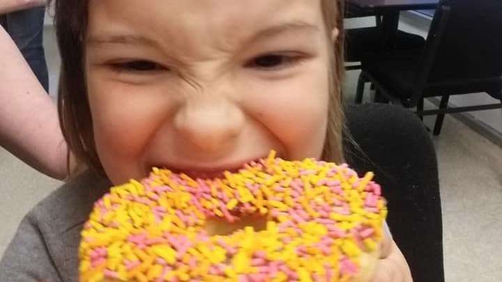 Elena loves the sprinkles and icing donut at yummies donuts and bbq in venice florida best breakfast in venice