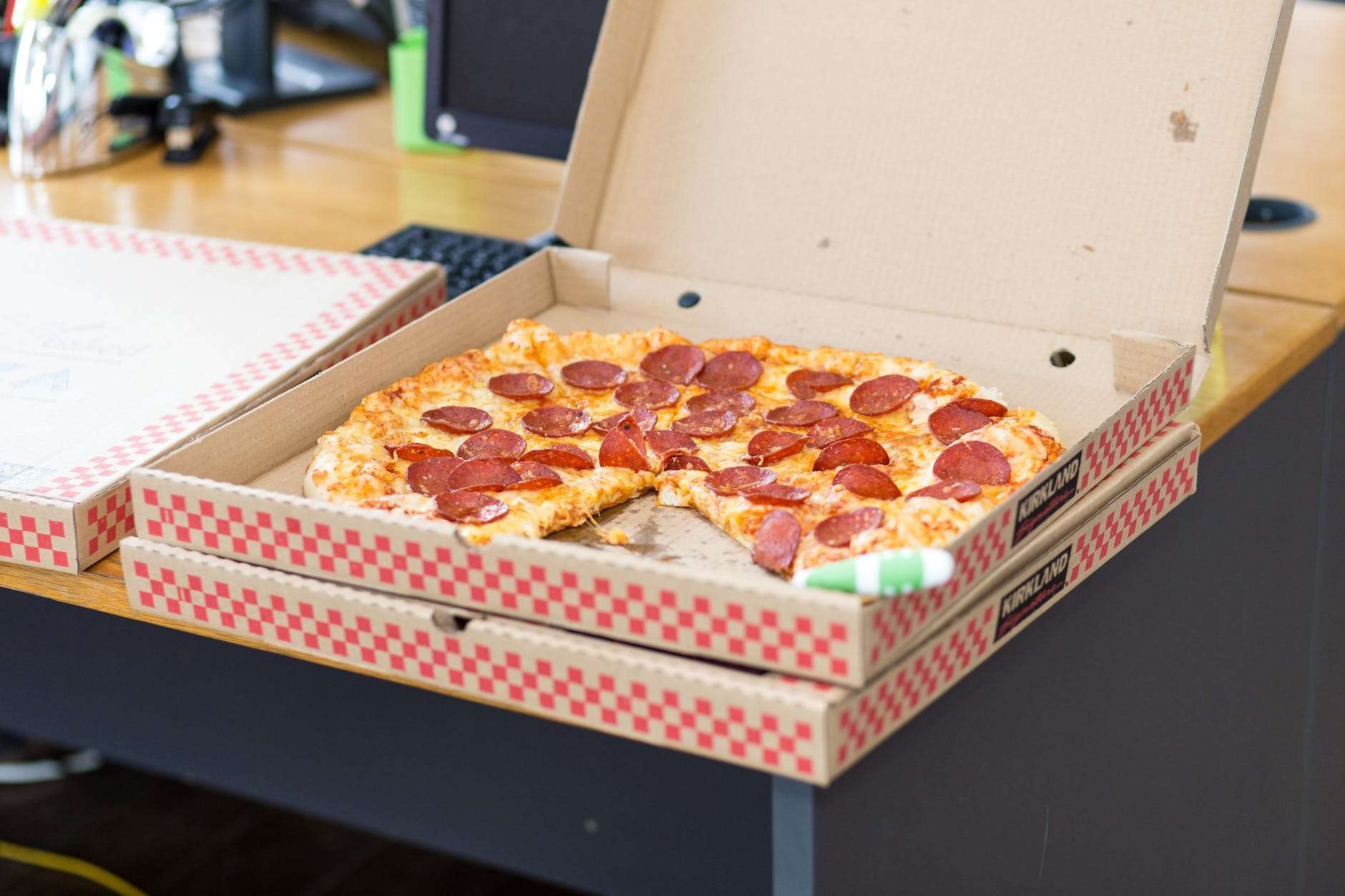 pizza with box on table