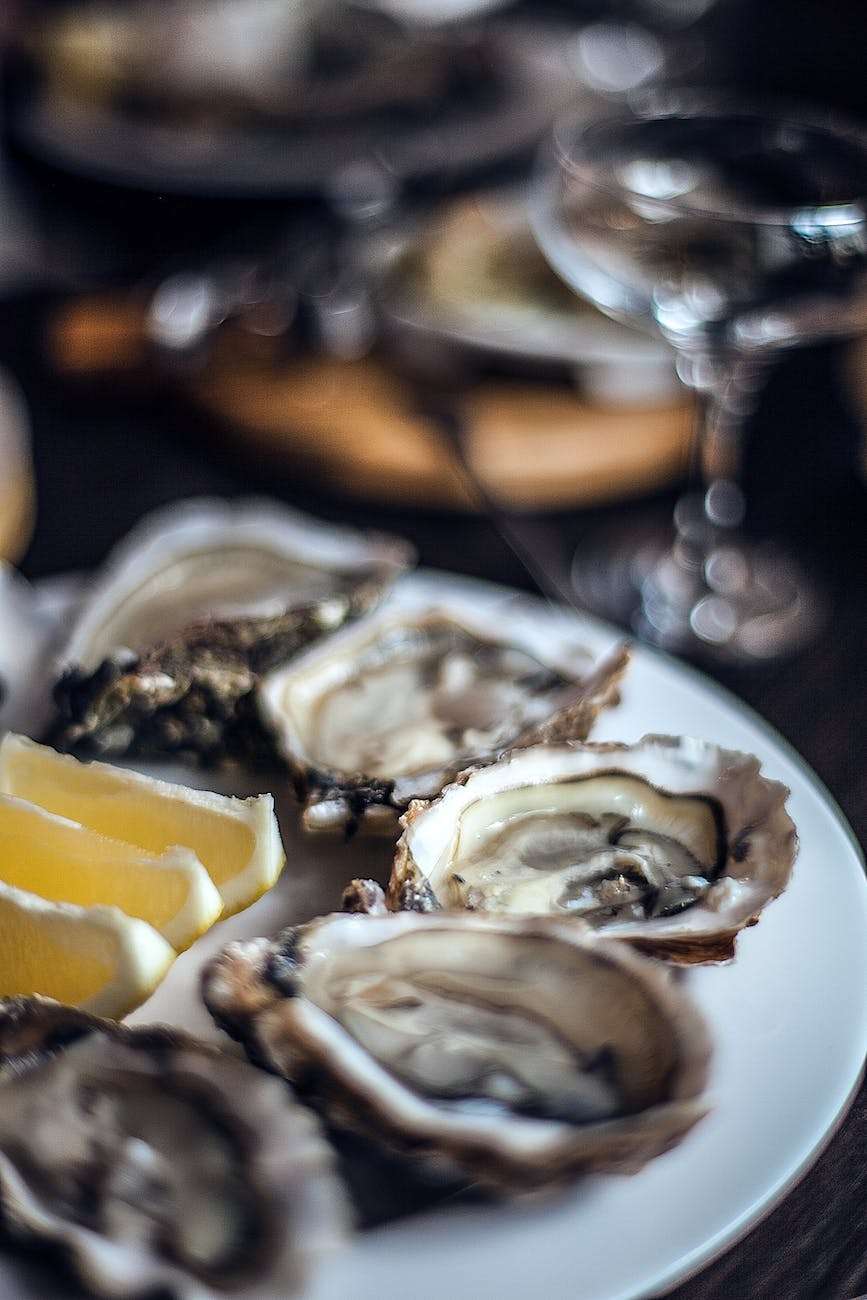 delicious oysters with lemon served in fancy restaurant