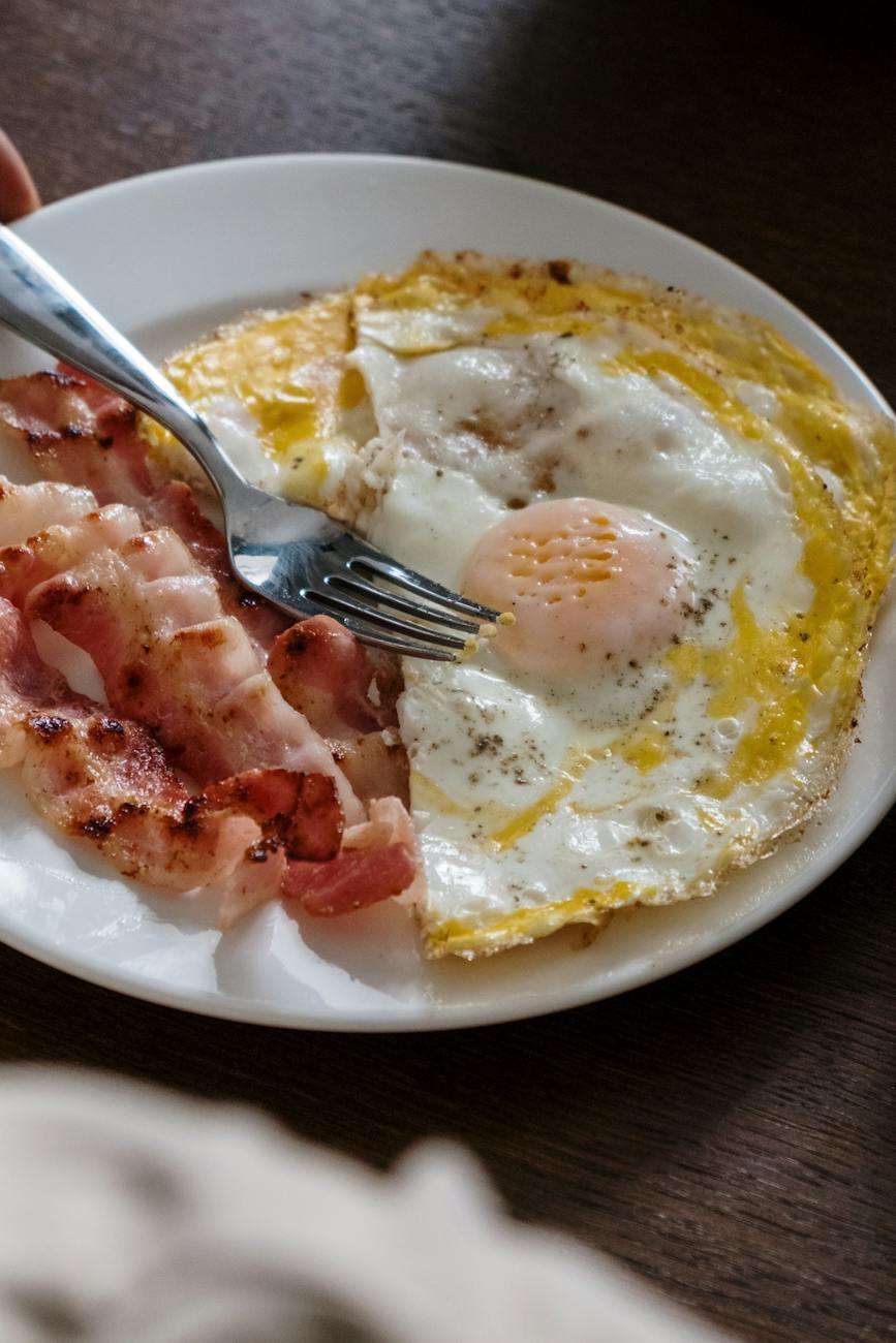 fried egg and bacon on the plate