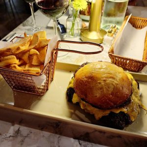 Signature Smash Burger Double beef patty, cheddar, caramelized onion, pickled jalapeños, secret sauce in a home made potato bun served with french fries